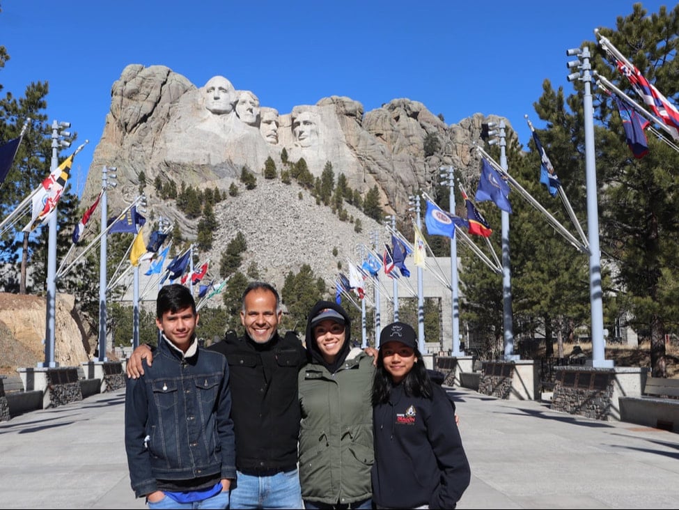 mount rushmore with family at the avenue of the flags