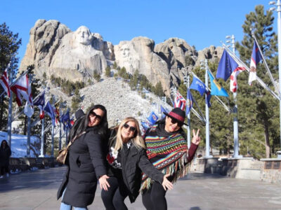 three guests at mount rushmore national memorial having fun