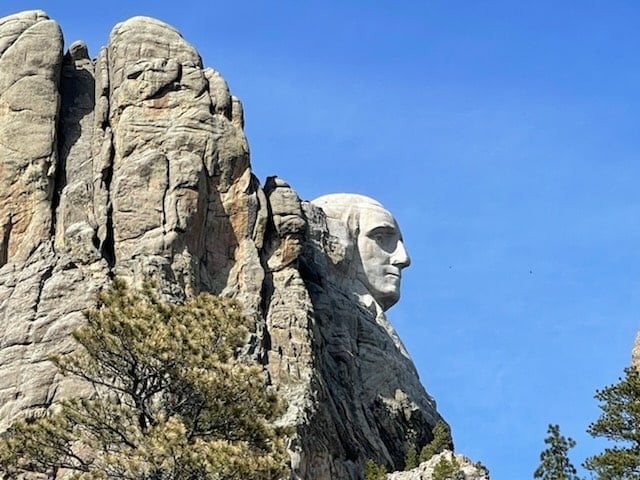 side view of george washington on mount rushmore national memorial from the viewing parking lot.