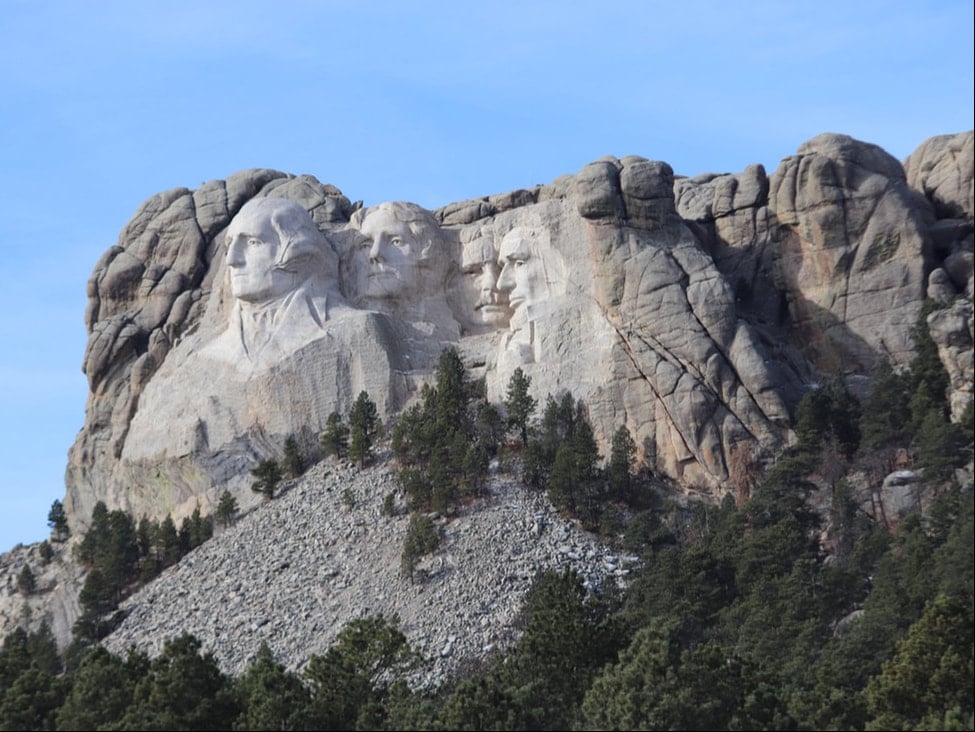 a stunning view of mount rushmore national memorial showcasing the intricate carvings of the four presidents' faces against a backdrop of the black hills.