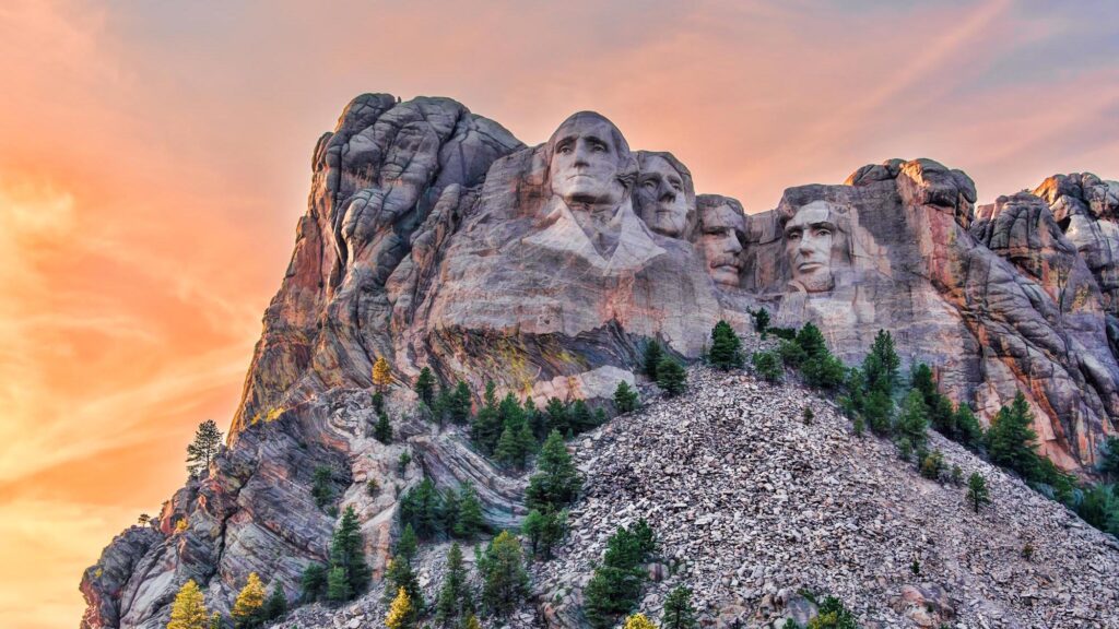 What Is Mount Rushmore Famous For? Discover Its Secrets! 65 mount rushmore carved in granite at sunrise with surrounding pine trees in the black hills, south dakota