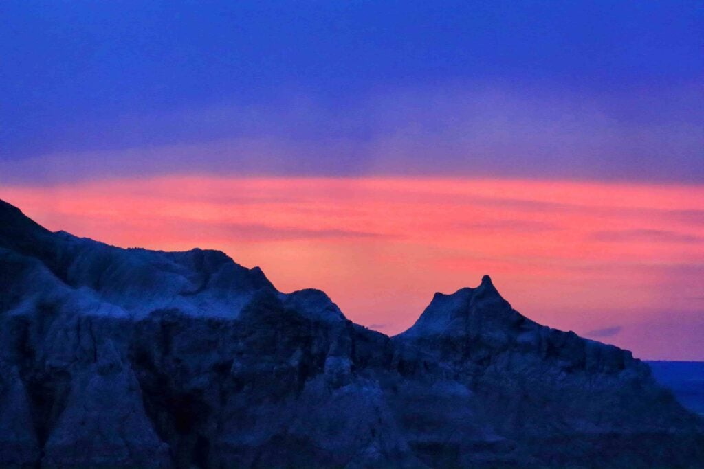 badlands sunset and night sky tours at the blue hour with a silhouette ridge in the foreground